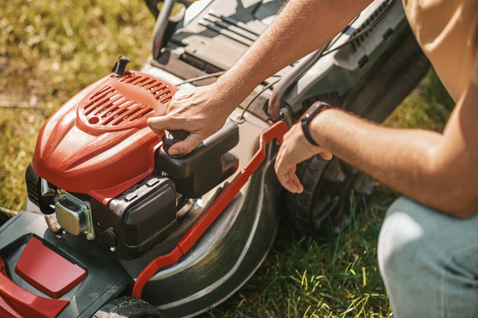 Opening the fuel cap on a walk-behind mower before winter storage