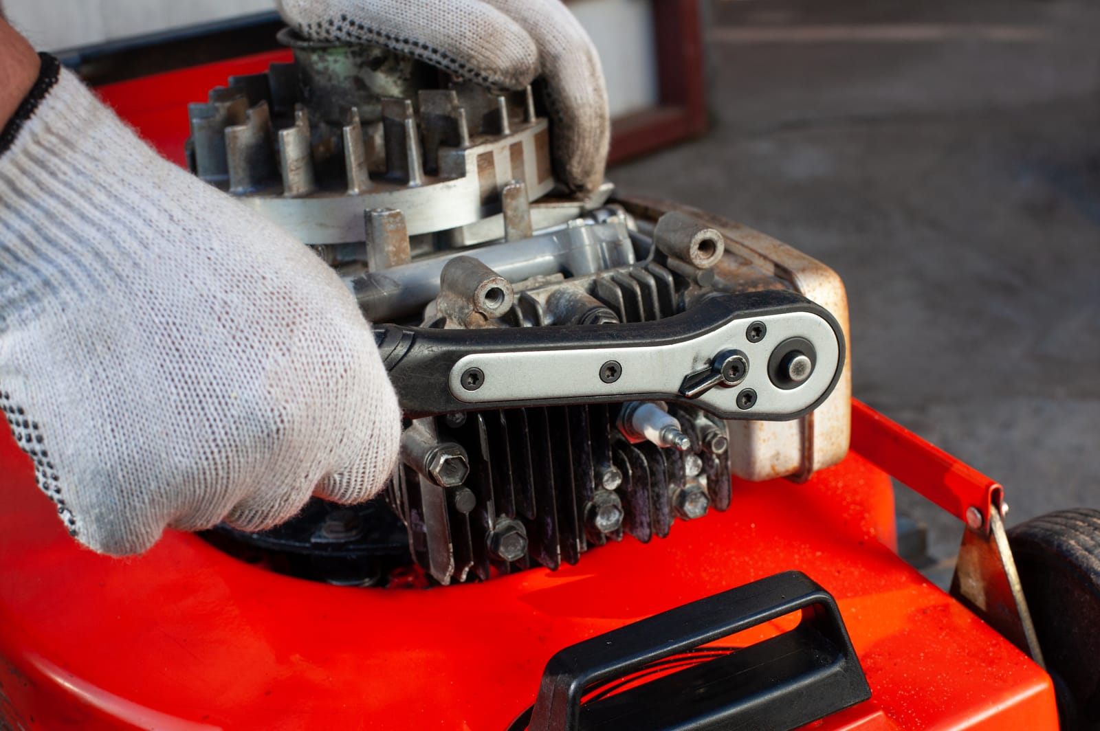 Reaching the spark plug on a mower engine with a socket wrench
